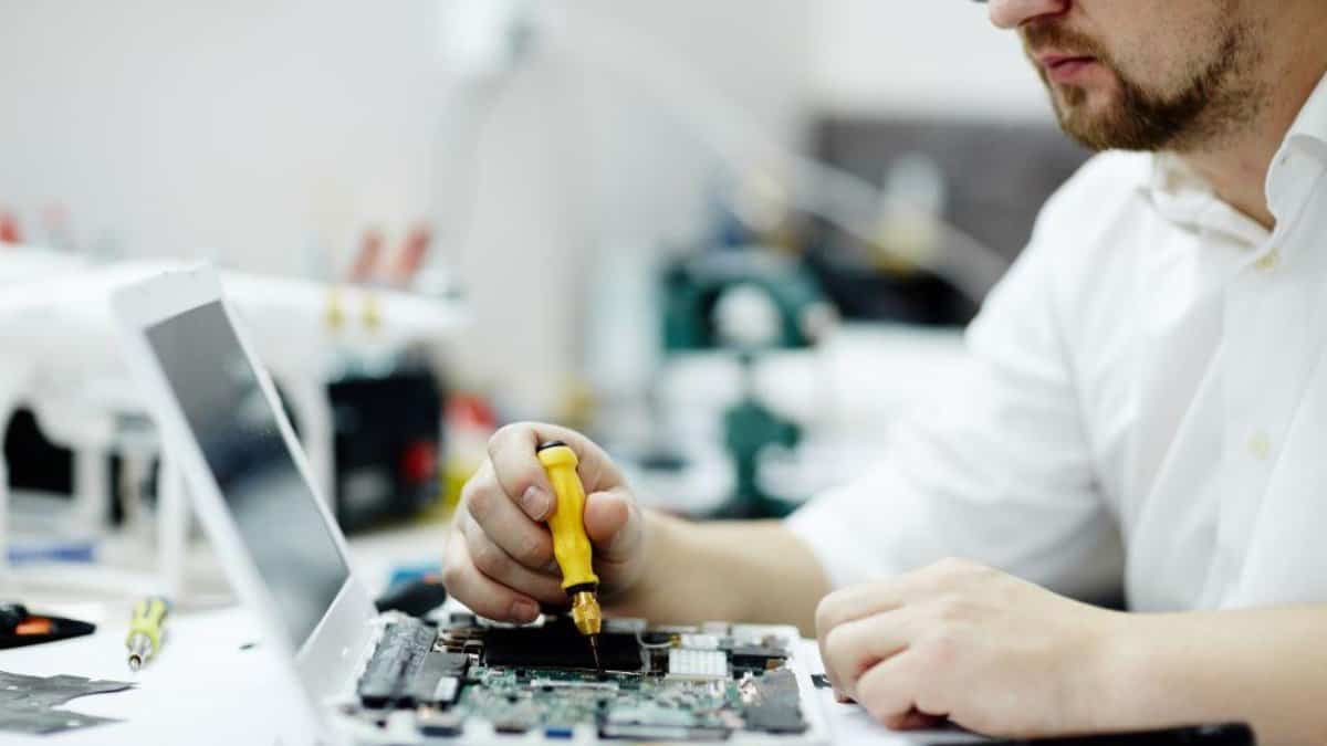 Person Repairing Laptop